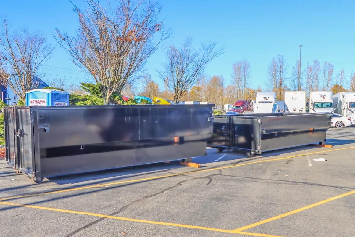 Professional dumpster rental service with roll-off container on residential driveway in Shelby